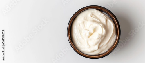 A bowl of Greek-styled sour cream on a white background