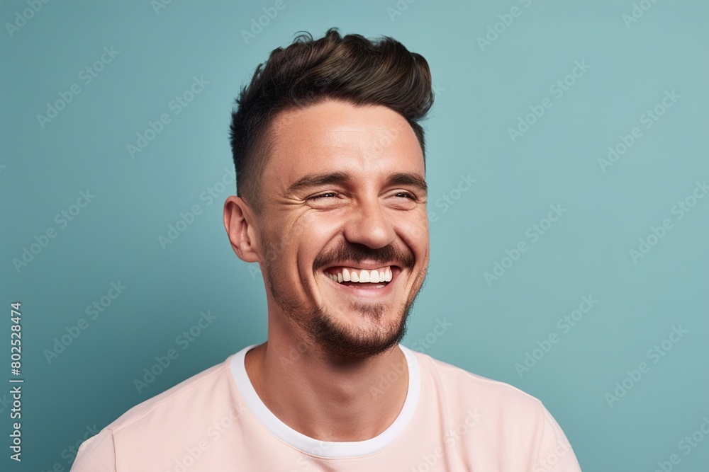 A man with a mustache and a pink shirt is smiling A man with a mustache and a pink shirt is smiling