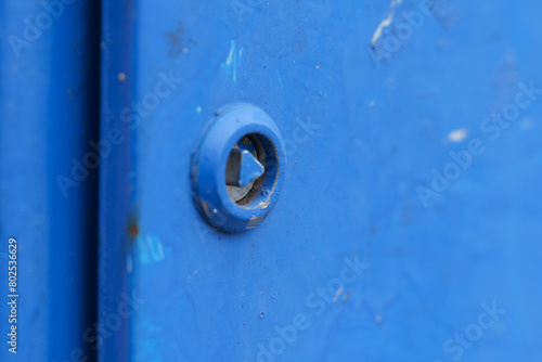 Close-up of Rusty Bolt on Blue Metal Surface