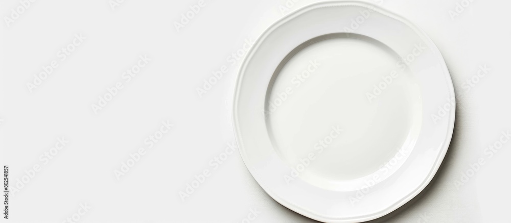 An empty plate pictured against a white background. Seen from a top-down perspective. An empty plate pictured against a white background. Seen from a top-down perspective.