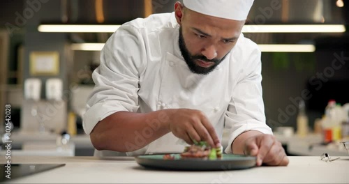 Chef, food and man plating in kitchen cleaning edge for gourmet meal at luxury diner. Hospitality, catering and male culinary worker wipe plate for neat dinner presentation at fine dining restaurant. photo