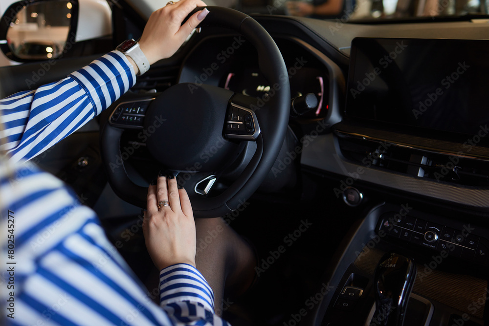 Hand of woman holding steering wheel of car Hand of woman holding steering wheel of car
