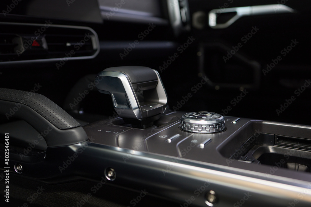 a close up of a car dashboard with a remote control a close up of a car dashboard with a remote control