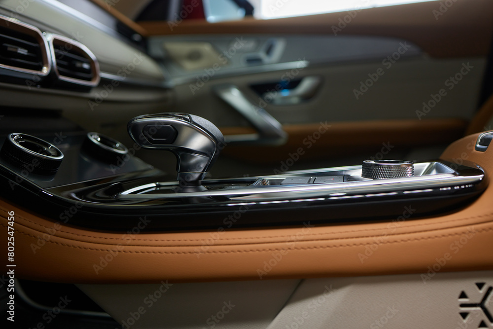 a close up of a car dashboard with a remote control a close up of a car dashboard with a remote control