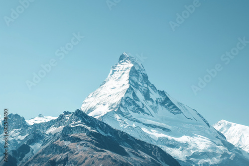 A snow-capped mountain peak against a clear blue sky