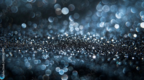 Shimmering silver sparkles on a dark background create a mesmerizing texture.