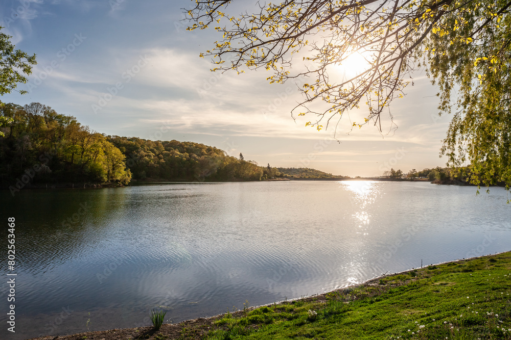 Obraz premium Panorama of Sotsko Jezero, or lake Sot, in Fruska Gora, in Serbia, Europe, in summer, at dusk, into the light. it is a major natural landmark of Vojvodina.