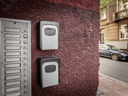 Lockbox, also called keysafe, or key safe, in front of the entrance door of a short term vacation rental, made at delivering keys to guests without contacts in a european city.