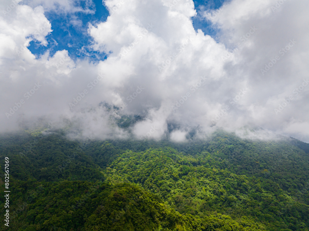 Scenic landscape with clouds over the mountain forest and jungle. Camiguin, Philippines. Scenic landscape with clouds over the mountain forest and jungle. Camiguin, Philippines.