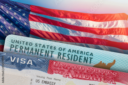 USA VISA and Green Card US Permanent resident. United States of America. Work and Travel ID documents. US Immigrant. Visa for Immigration. Embassy USA. Visa in passport. American flag on background