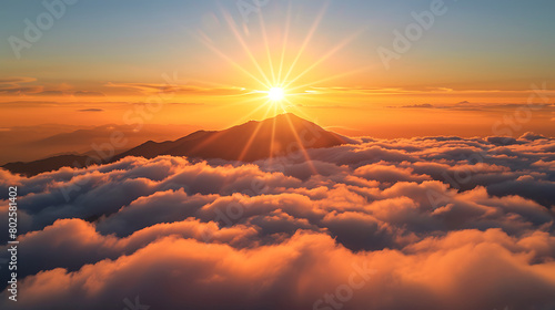 a breathtaking sunrise over a sea of clouds, with the sun casting its golden rays across the sky and illuminating the silhouette of a mountain peak