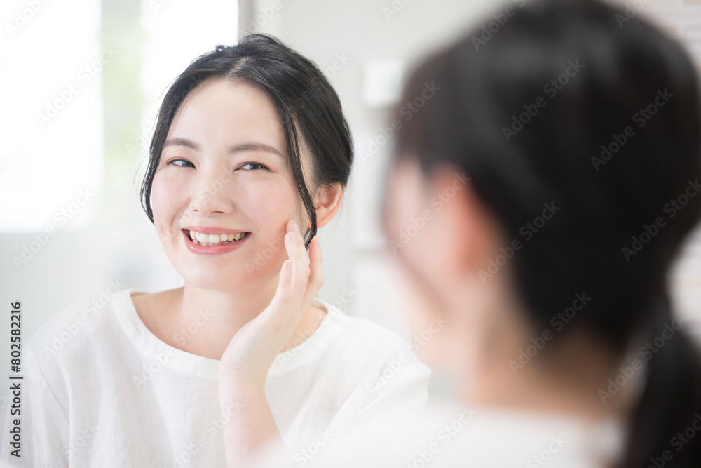 Woman concerned about skin texture while looking in the mirror Image of skin care and beauty Woman concerned about skin texture while looking in the mirror Image of skin care and beauty