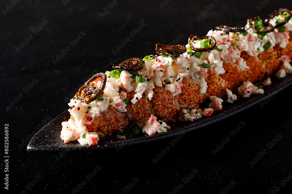 Sushi roll set. Traditional Japanese cuisine. Isolated on black background. tampico sauce Sushi roll set. Traditional Japanese cuisine. Isolated on black background. tampico sauce