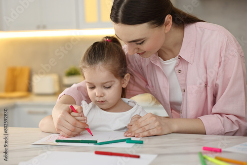 Wallpaper Mural Mother and her little daughter drawing with colorful markers at table in kitchen Torontodigital.ca