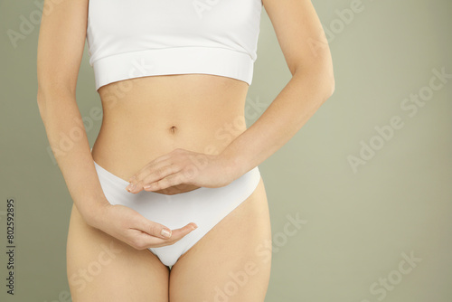 Gynecology. Woman in underwear on grey background, closeup. Space for text