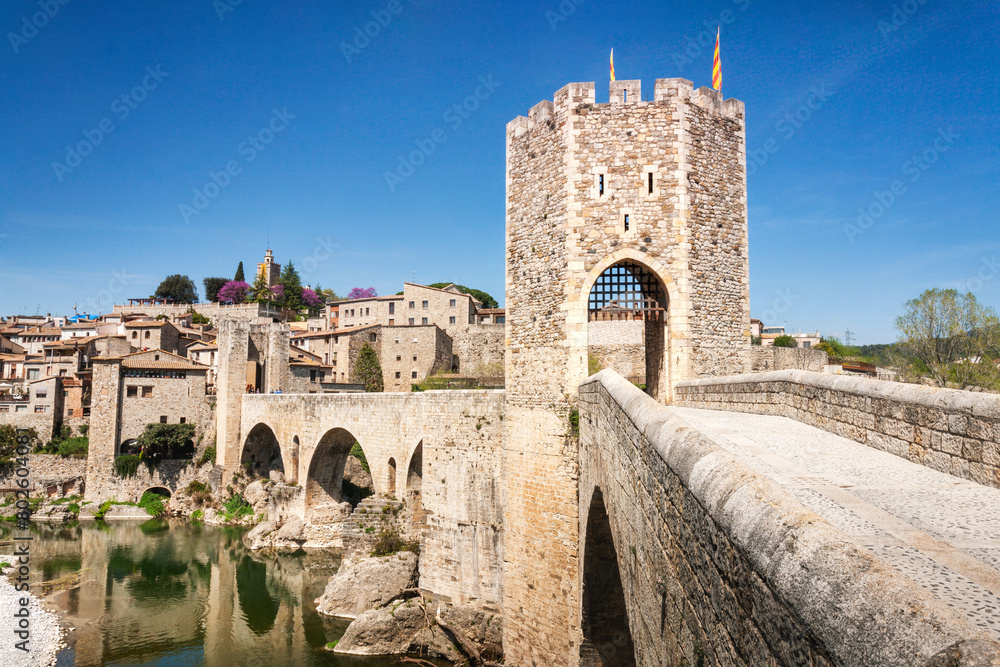 The medieval bridge of Besalú, Girona, Catalonia, Spain, with the village in the background.