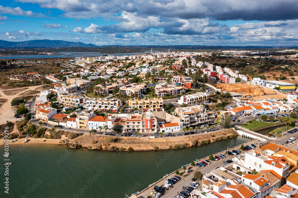 Fototapeta premium View of Ferragudo village in Algarve, Portugal. Old sea town of Ferragudo. View of Ferragudo from the air. Ferragudo is a beautiful coastal village in Algarve, Portugal, Europe.