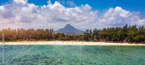 Beach of Flic en Flac with beautiful peaks in the background, Mauritius. Beautiful Mauritius Island with gorgeous beach Flic en Flac, aerial view from drone. Flic en Flac Beach, Mauritius Island. © daliu