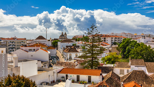 View of the city of Tavira, charming architecture of Tavira, Algarve, Portugal. Santiago of Tavira church in the old town of the beautiful city of Tavira in a sunny day. Algarve region, Portugal