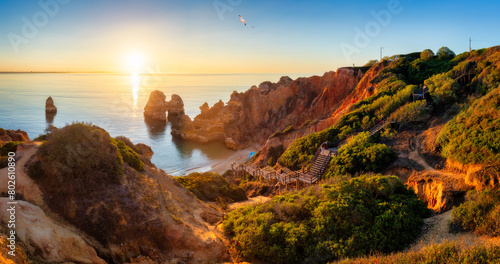 Camilo beach (Praia do Camilo) in Lagos, Algarve, Portugal. Wooden footbridge to the beach Praia do Camilo, Portugal. Picturesque view of Praia do Camilo beach in Lagos, Algarve region, Portugal.