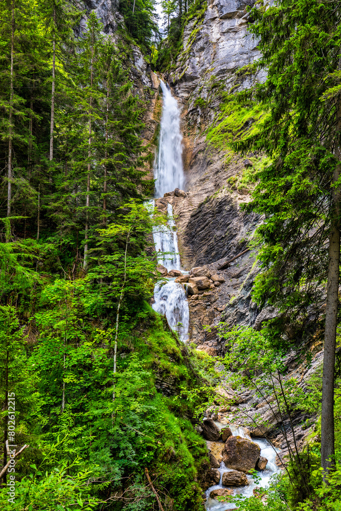 Fototapeta premium The beautiful three-part Lower Martuljek Waterfall in the Julian Alps, Slovenia. Triglav National Park. Scenic mountain with Martuljek waterfall in Triglav national park in Julian Alps, Slovenia.