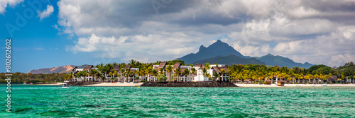 Tropical paradise  best beaches of Mauritius island  luxury resorts. Recreational tourism landscape. Luxurious beach resort with spa swimming pool and beach chairs or leisure loungers under umbrellas.