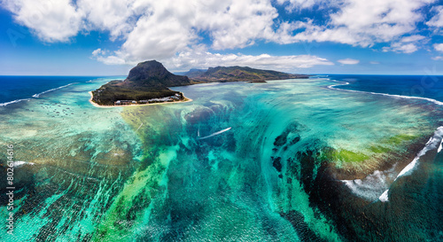 Obraz na płótnie Aerial view of Mauritius island panorama and famous Le Morne Brabant mountain, beautiful blue lagoon and underwater waterfall. Le Morne Brabant peninsula and Underwater Waterfall, Mauritius. w salonie