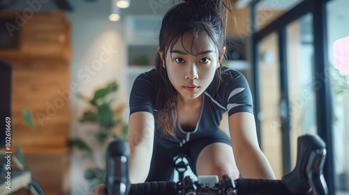 woman cyclist. She is exercising at home. She is playing games