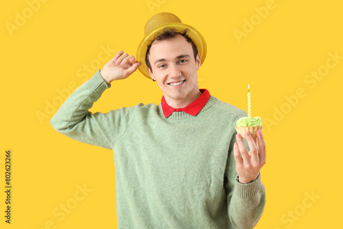 Young man with birthday cak...