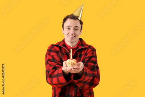 Young man with birthday cak...
