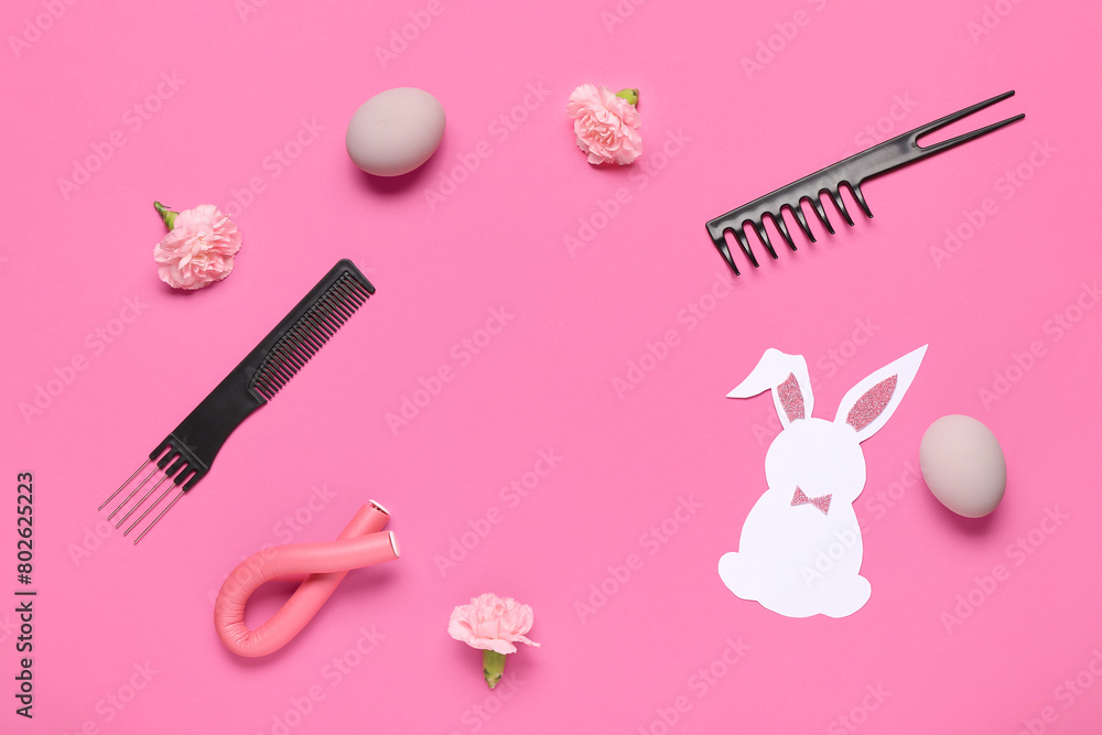 Frame made of hairdressing accessories with flowers, Ester eggs and bunny on pink background Frame made of hairdressing accessories with flowers, Ester eggs and bunny on pink background