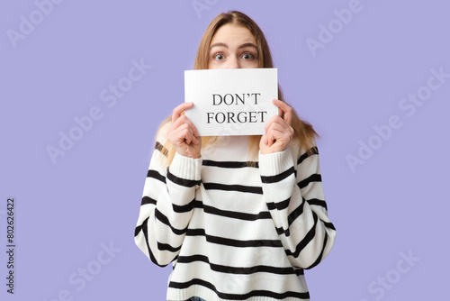 Excited young woman holding...