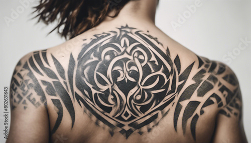 tribal tattoo's on persons back side, isolated white background, copy space for text
 photo