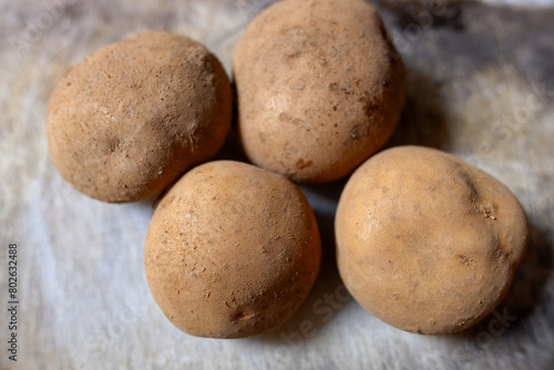 Freshly Harvested Potatoe on Woven Bamboo Tray, healthy food, stock photo.