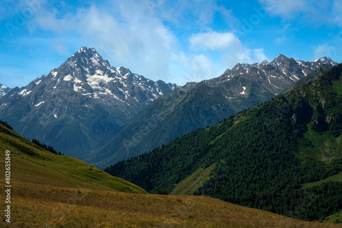 View of the peaks of the North Caucasus mountains near the Arkhyz ski resort on a sunny summer day, Karachay-Cherkessia, Russia © Ula Ulachka