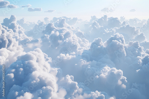 Puffy white clouds drift across a bright blue sky in a beautiful daytime cloudscape photo