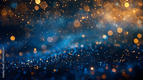 A navy blue background with golden particles features an abstract design. Gold foil texture sparkles amidst the bokeh effect of Christmas lights shimmering. photo