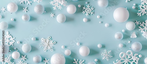 Christmas or winter arrangement featuring a design composed of white balls and snowflakes on a soft blue backdrop. Emphasizing the themes of Christmas  winter  and the new year.