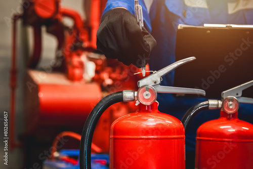 Engineer check fire extinguisher tank in the fire control room for safety in factory or industry.