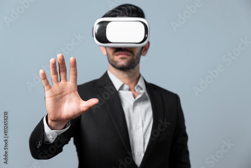 Professional smart business man holding something while wearing VR glasses. Caucasian project manager with virtual reality goggles while present technology innovation with white background. Deviation.