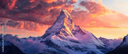 Photo of A Snow Covered Mountain Peak At sunset atmosphere
