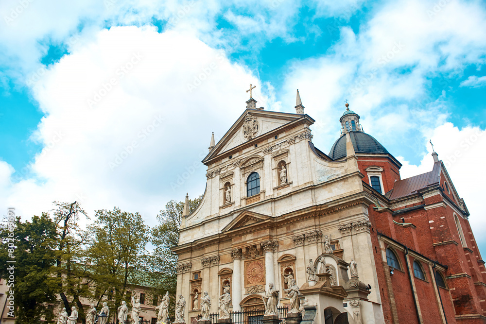 Fototapeta premium Ancient European architecture. The beautiful facade of the church building on the Market Square in the center of Krakow.