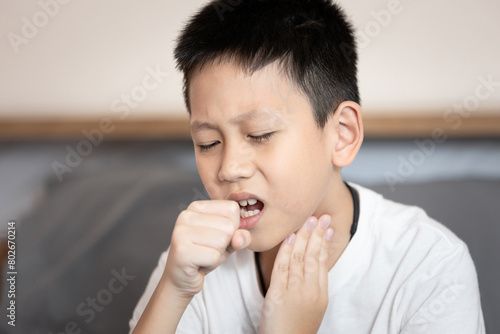Sick child boy suffering from coughing,sore throat,chronic cough with mucus,Acute bronchitis or chest cold,Pneumonia,Respiratory disease,infection or inflammation of the bronchial or lung in children photo