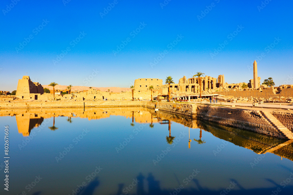 View of the Karnak Temple Sacred Lake-the largest of its kind,built by Pharoah Tuthmosis III around 1460 BC used for sacred rituals at the Karnak temple complex dedicated to Amun-Re in Luxor,Egypt