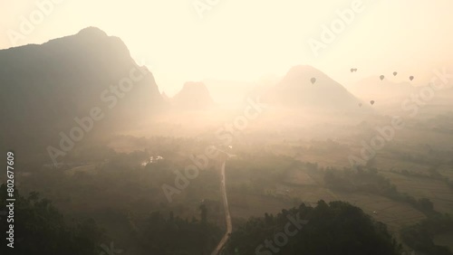 drone shot of sunrise through mountain valley in Vang Vieng, the adventure capital of Laos photo