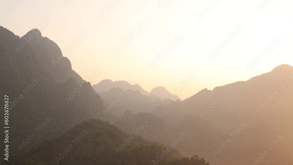 golden sunrise between peaks in Vang Vieng, the adventure capital of Laos golden sunrise between peaks in Vang Vieng, the adventure capital of Laos