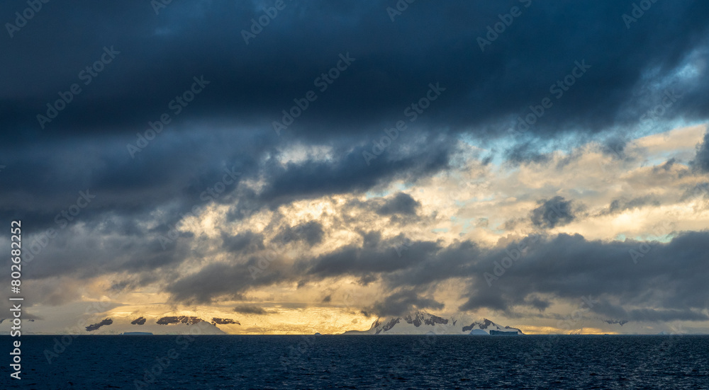 An Antarctic landscape, taken during the golden hour, just after sunrise, in the Gerlache Strait.
