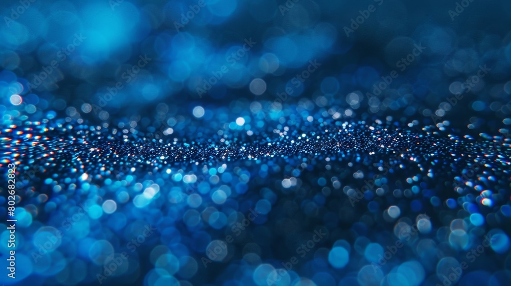 Vivid blue light bokeh on a dark background creating a sparkling and enchanting abstract pattern. Vivid blue light bokeh on a dark background creating a sparkling and enchanting abstract pattern.