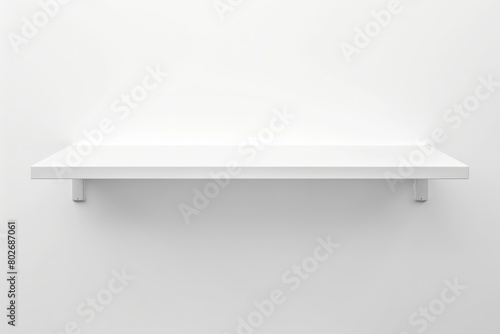 A white shelf mounted on a white wall, creating a minimalistic and clean look photo