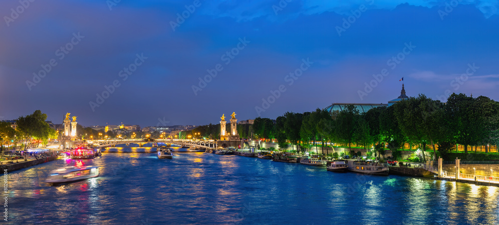 Paris France, panorama city skyline night at Seine River with Pont Alexandre III bridge and Grand Palais